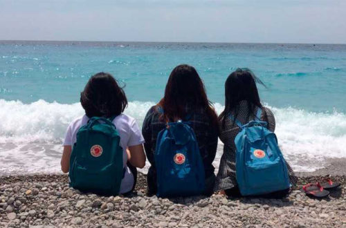 one woman and two children on a beach